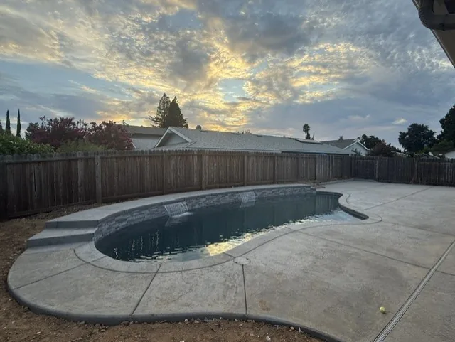 El Dorado Hills project β Freeform pool stamped concrete deck sunset by Pinnacle Pools and Landscape, Sacramento CA