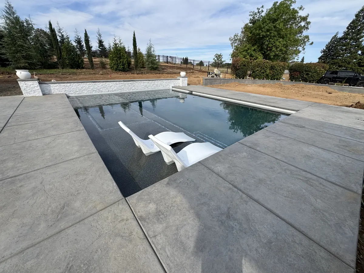 Pool Decks project in El Dorado Hills β Geometric pool dark finish lounge chairs by Pinnacle Pools and Landscape, Sacramento CA