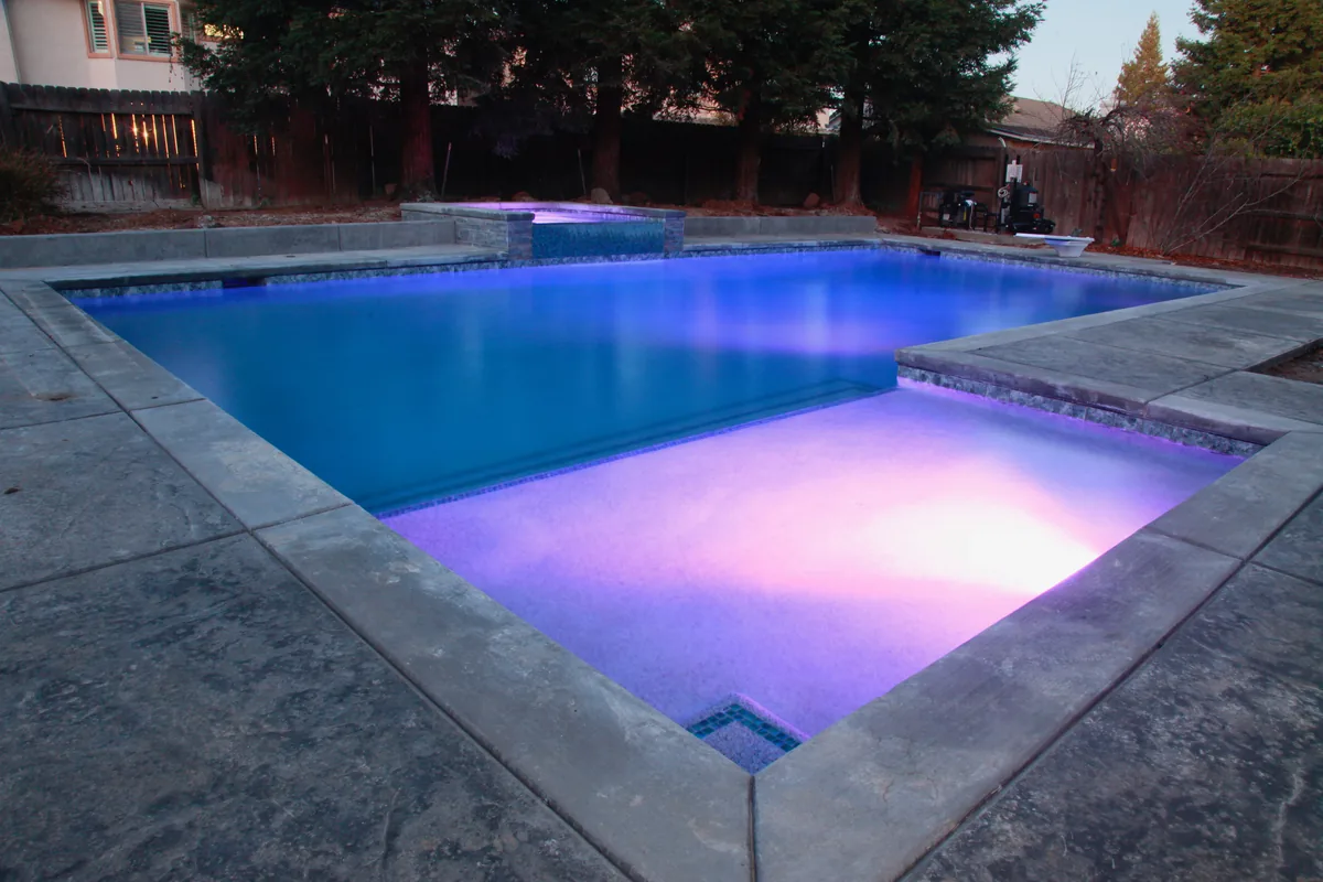 Geometric pool spa color led night by Pinnacle Pools and Landscape, Sacramento CA