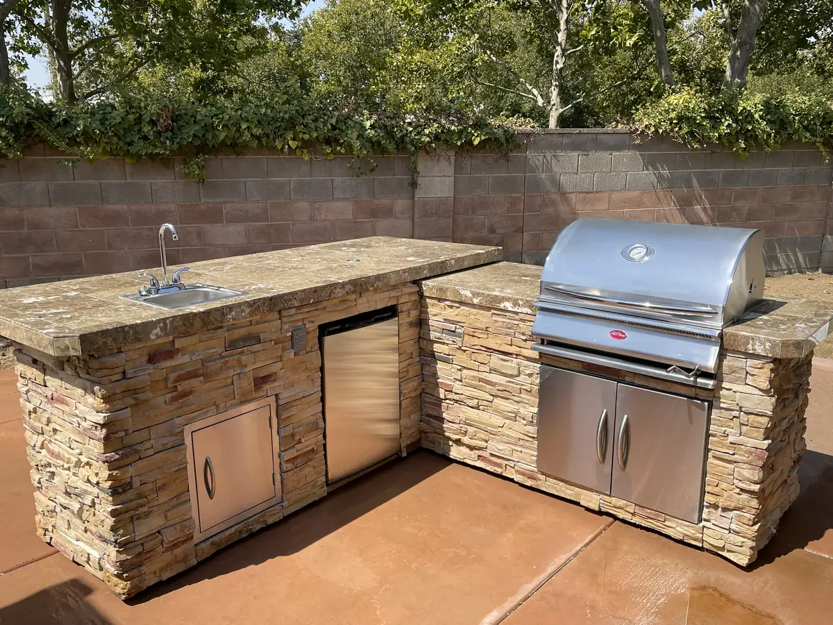 Concrete project in Folsom β Outdoor kitchen stone veneer grill island by Pinnacle Pools and Landscape, Sacramento CA