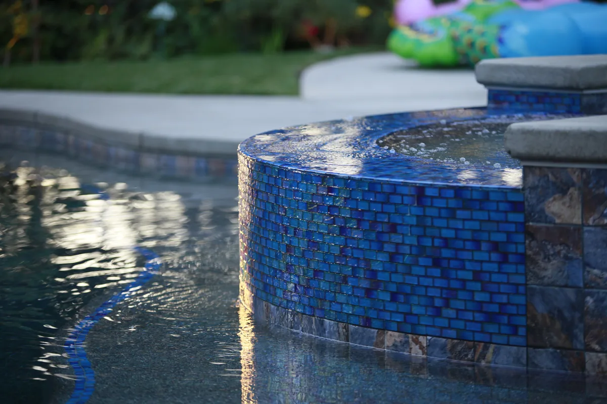 Pool Construction detail — Pool glass mosaic tile raised wall by Pinnacle Pools and Landscape, Sacramento CA
