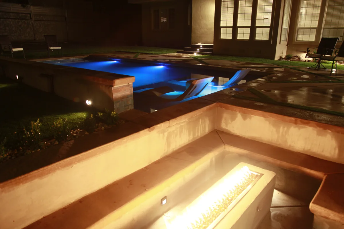 Pool linear fire feature night by Pinnacle Pools and Landscape, Sacramento CA