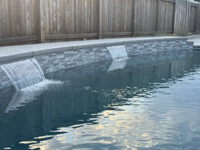 Pool sheer descent waterfall stacked stone by Pinnacle Pools and Landscape, Sacramento CA