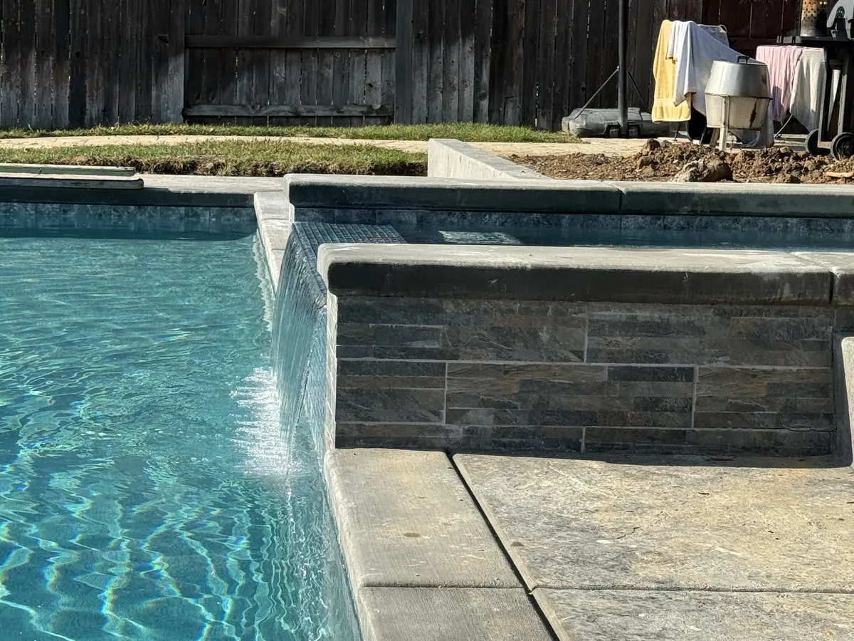 Pool Construction detail — Pool waterfall stone veneer wall by Pinnacle Pools and Landscape, Sacramento CA