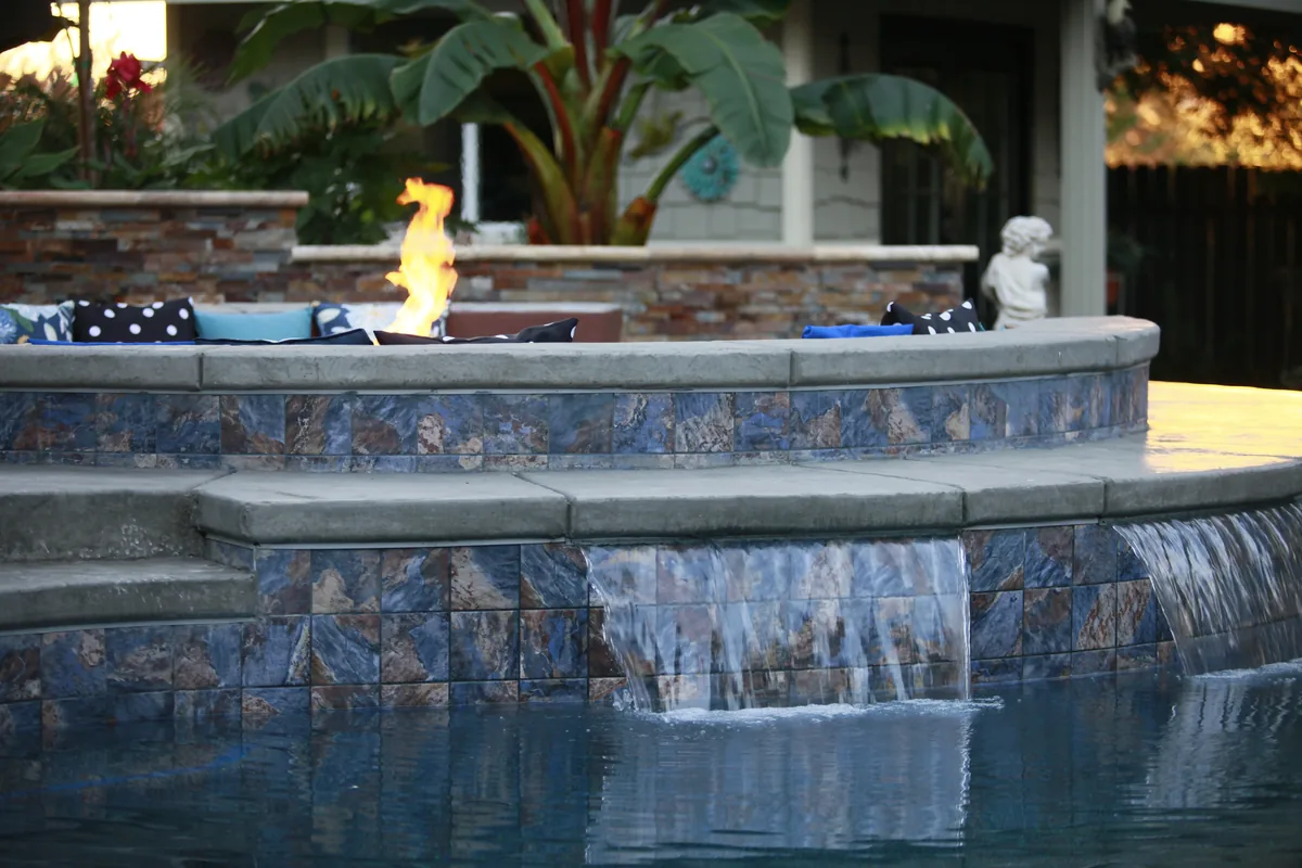 Fire Pits detail — Raised spa fire bowl glass tile spillway by Pinnacle Pools and Landscape, Sacramento CA