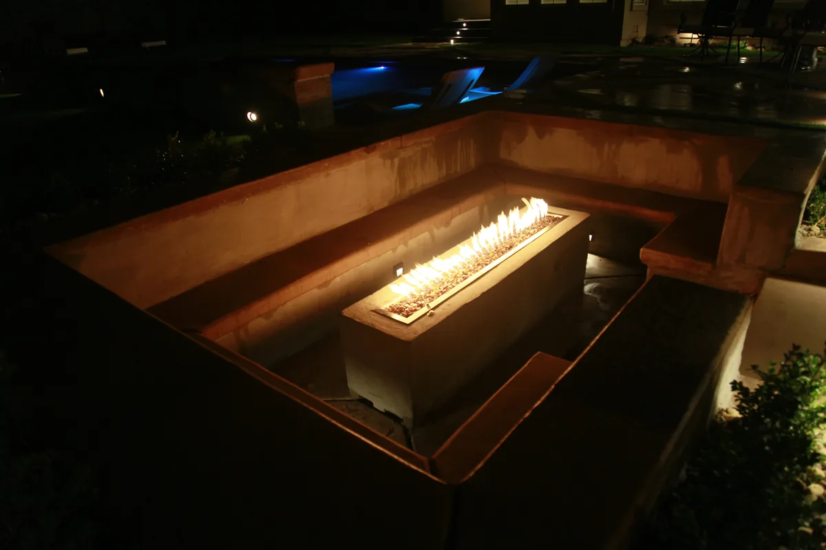 Raised spa linear fire feature night by Pinnacle Pools and Landscape, Sacramento CA