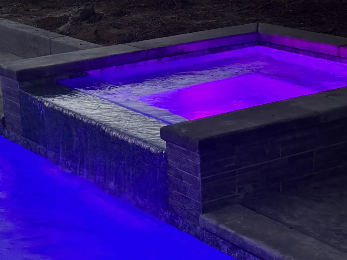 Pool Remodeling detail — Raised spa spillway purple led lighting by Pinnacle Pools and Landscape, Sacramento CA